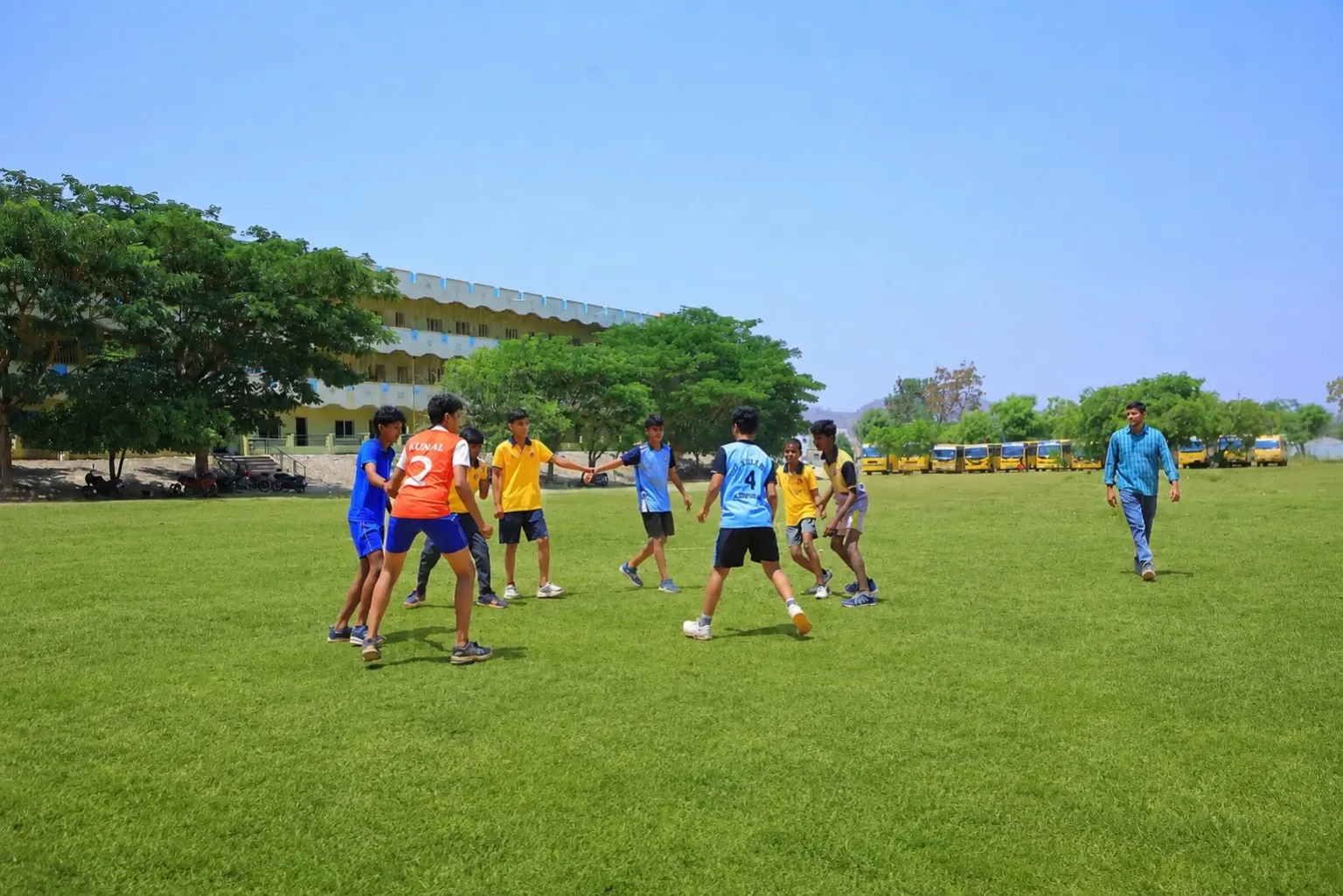 Students playing sports on the Blue Moon campus ground