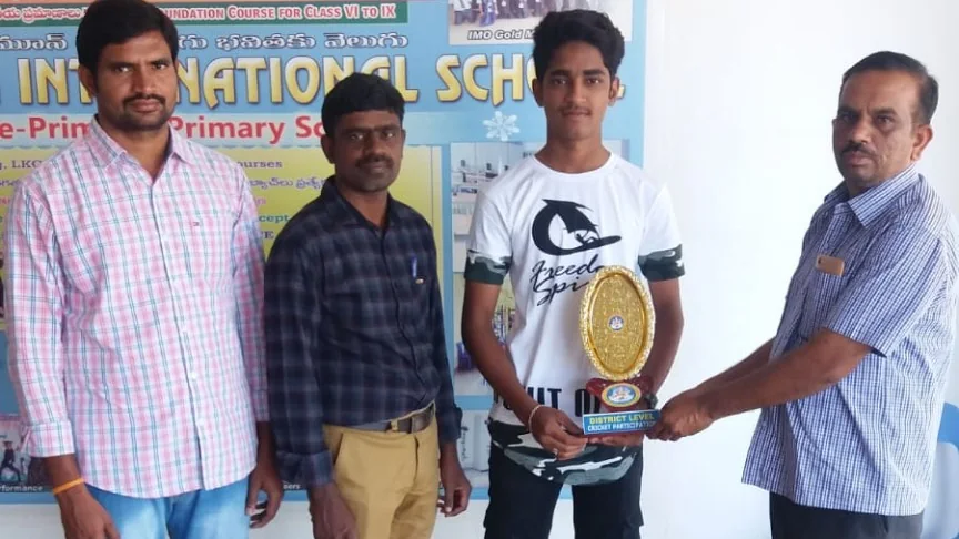 Blue Moon student receiving trophy for State Level Cricket participation